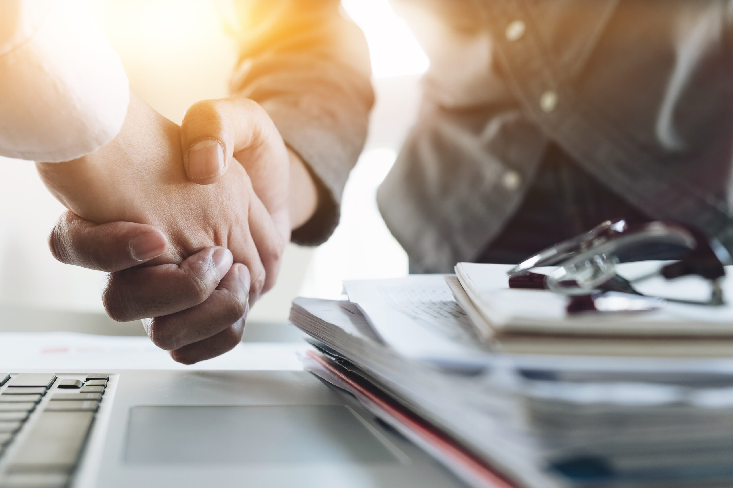 Close up of Business people shaking hands, finishing up meeting,