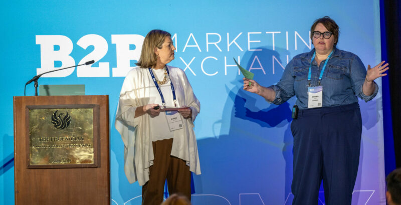 Two women on stage mid-discussion