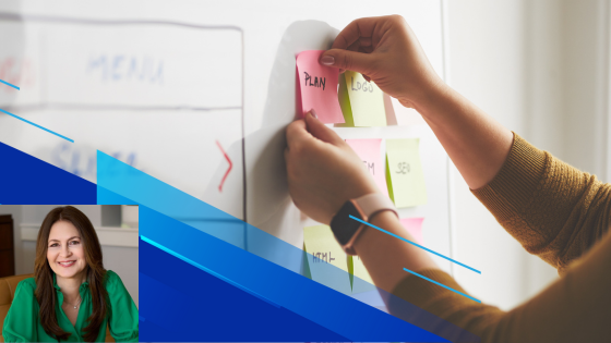 Woman placing sticky notes on white board