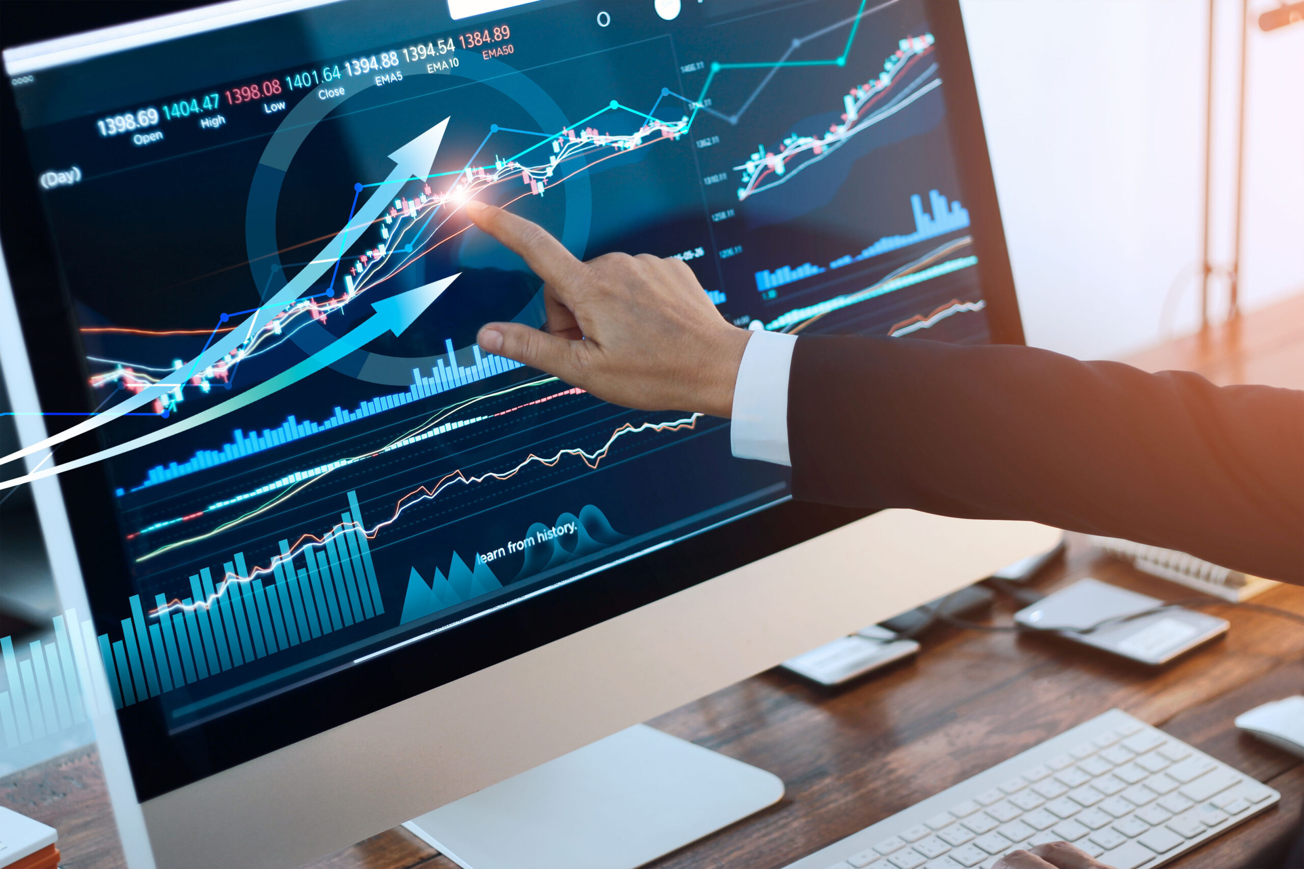 Analyzing data. Hand of businessman touching graph and chart stock market on screen in work place.