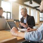 Mixed sales team working through presentation before meeting