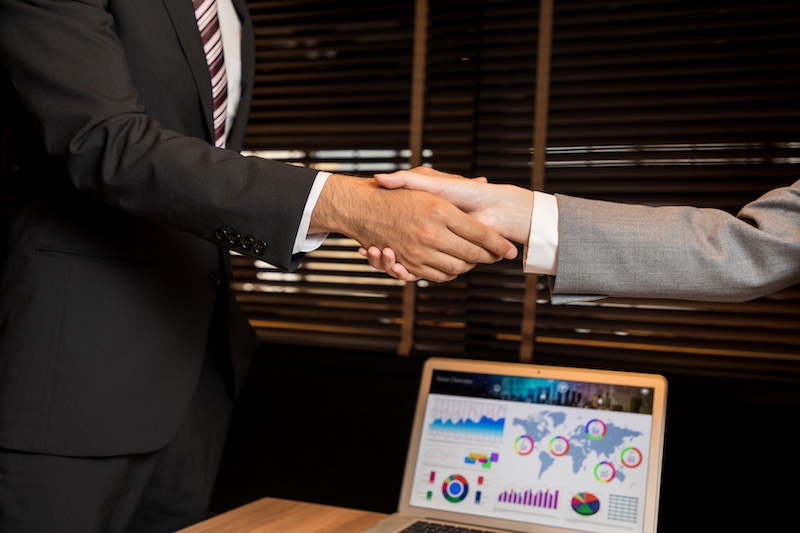 businessman and businesswoman shaking hands.