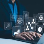 B2B business strategy concept. Businessman working with a B2B virtual interface on a laptop, conceptualizing strategy, partnership, targets in business to business services. E commerce, B2B Marketing,