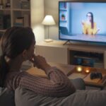 Woman watching an online course on her TV