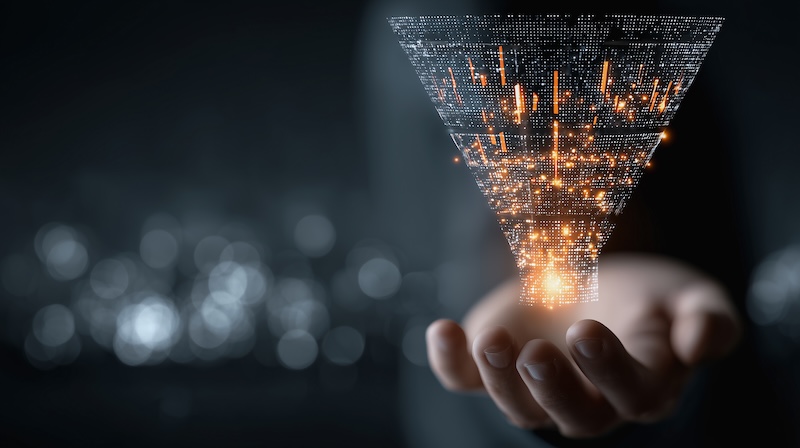 Hands present a marketing funnel with digital data overlay