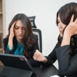 Hightouch Data Frustrated Businesswomen Analyzing Data on Tablet in Modern Office Setting