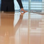 Adswerve, Apollo.io New CEOs Midsection Of Businessman With Hands On Conference Table