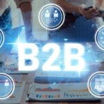 Demandbase #COSeries Collaborative Business Partnership in B2B Environment with Laptops, Documents, and Digital Icons Representing Networking, Communication, and Teamwork Trope