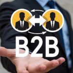 Greenfire Strategy Acquires 21b Consulting B2B marketing strategy concept. business to business, E commerce, Professional business and commerce collaboration. Person holding B2B icon on virtual screen.
