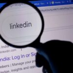 LinkedIn Is Emerging as AI Search Visibility Channel A magnifying glass showing linkedin on a computer screen with google search results