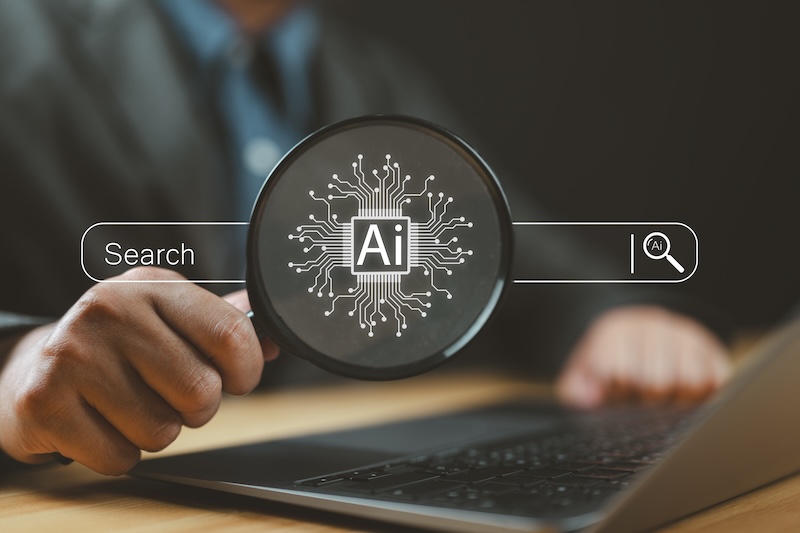 Rampiq Reveals What Content AI Search Engines Cite Most In B2B AI tech search concept, businessman use magnifying glass focus to AI search engine bar for data search optimization by artificial intelligence technology.